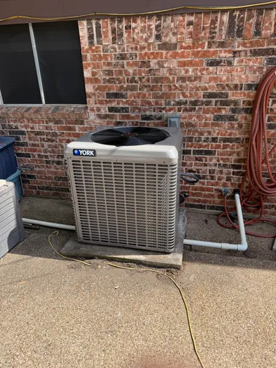 AC condenser installed outside a home