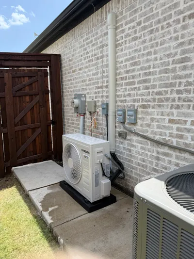 Ductless mini-split outdoor unit installed on a home